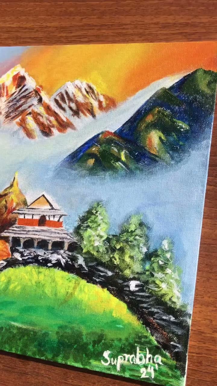Vertical process film of a colorful mountain landscape and temple painting in progress.